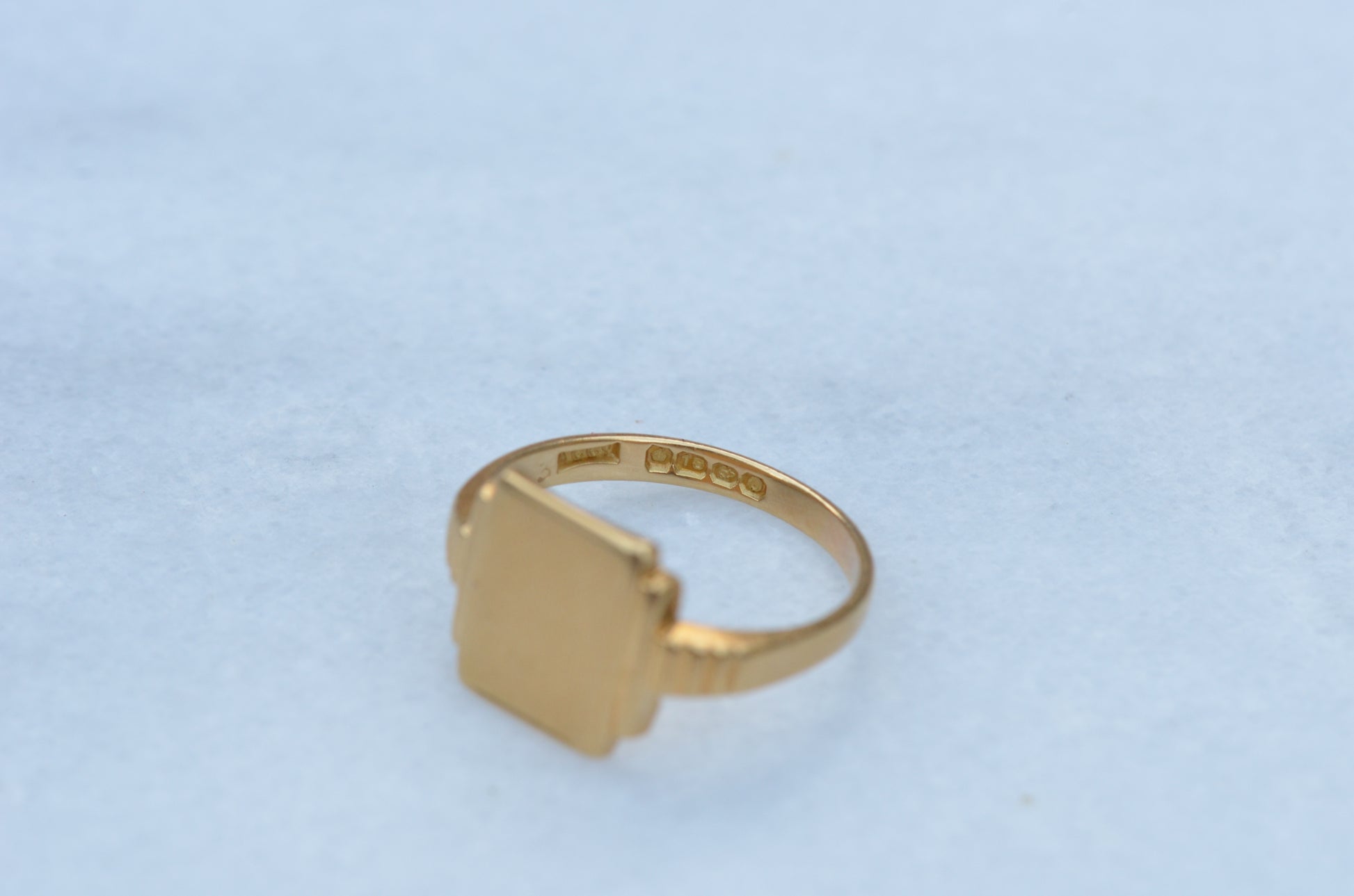 The ring is viewed looking into the band to see the crisp full series of British hallmark stamps.