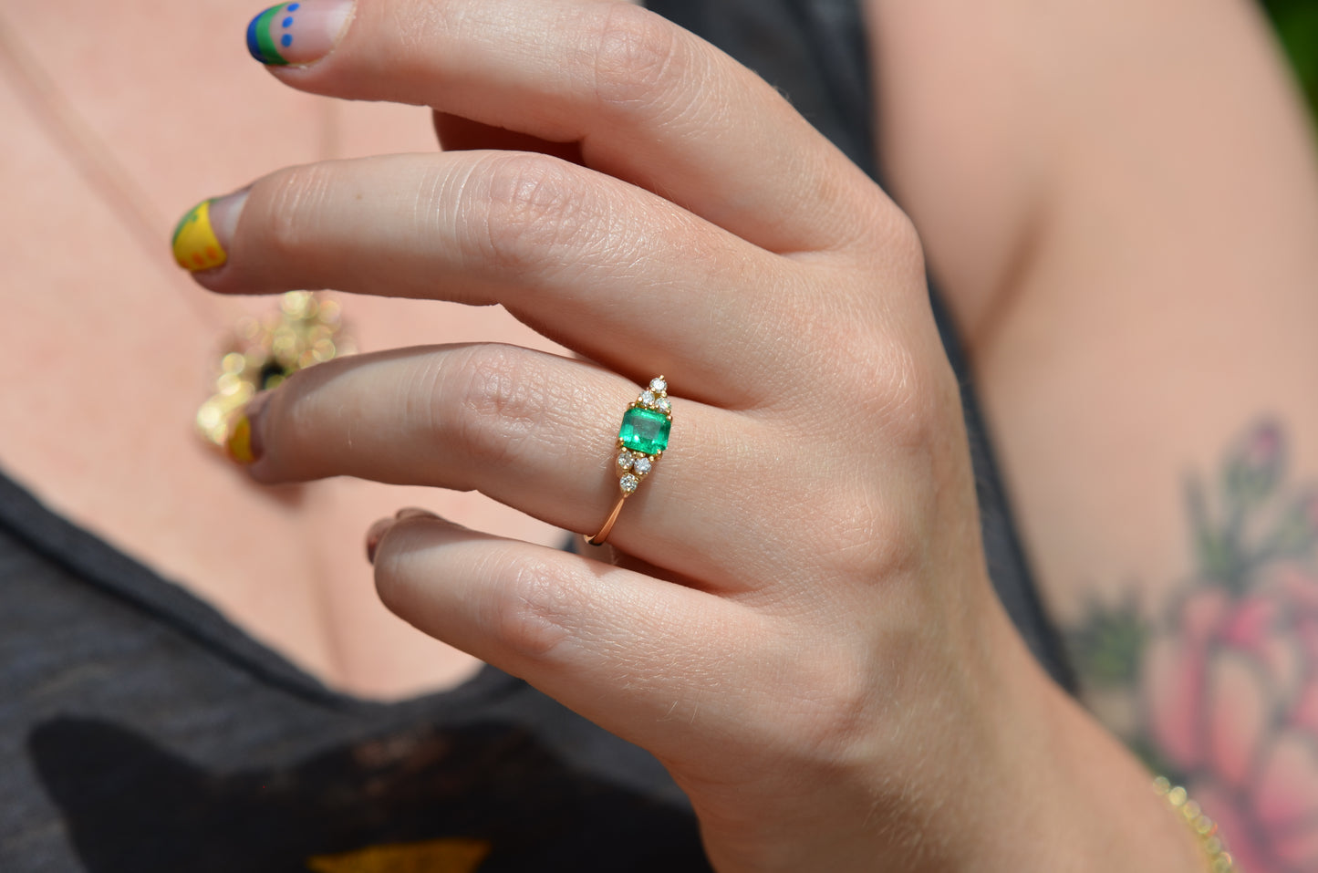 Medium-close photo of the vintage ring on the hand of a Caucasian model's left ring finger in order to show scale when worn.