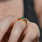 Medium-close photo of the vintage ring on the hand of a Caucasian model's left ring finger in order to show scale when worn. View is highlighting the gallery of the ring and the rise off the finger.