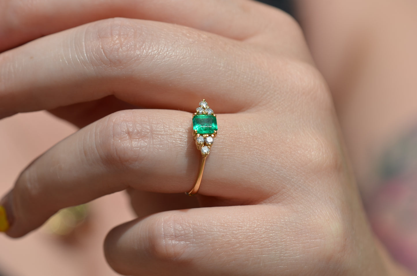 Medium-close photo of the vintage ring on the hand of a Caucasian model's left ring finger in order to show scale when worn.