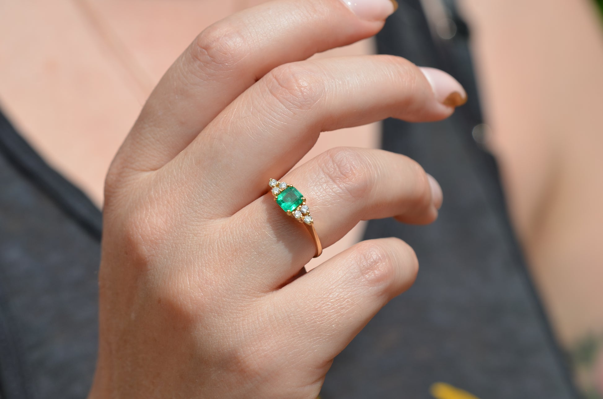 Medium-close photo of the vintage ring on the hand of a Caucasian model's right ring finger in order to show scale when worn.