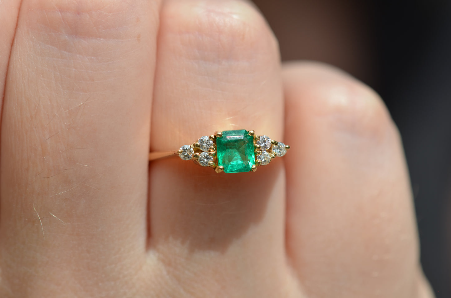 Macro photo of the vintage ring on the hand of a Caucasian model's right ring finger in order to show scale when worn.