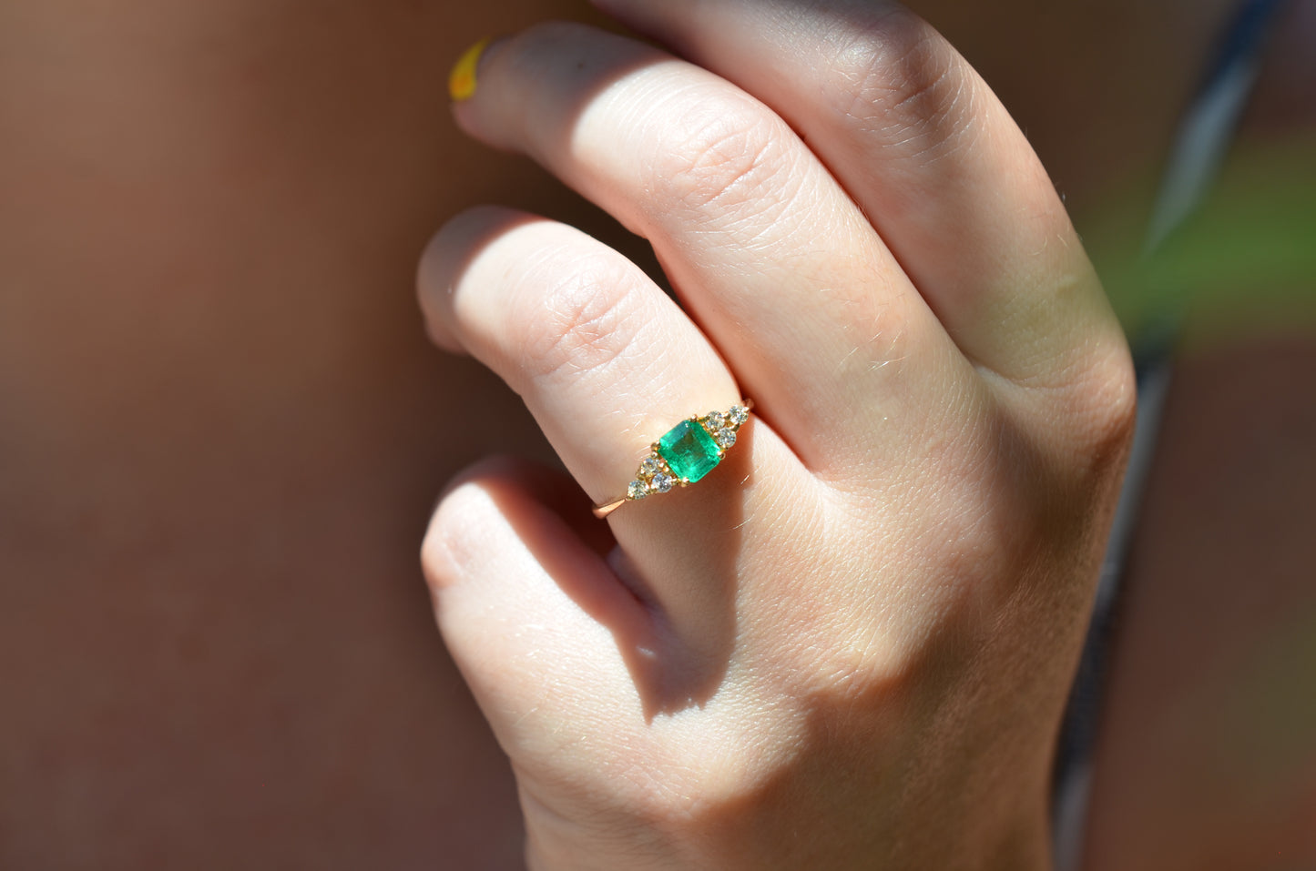 Medium-close photo of the vintage ring on the hand of a Caucasian model's left ring finger in order to show scale when worn.