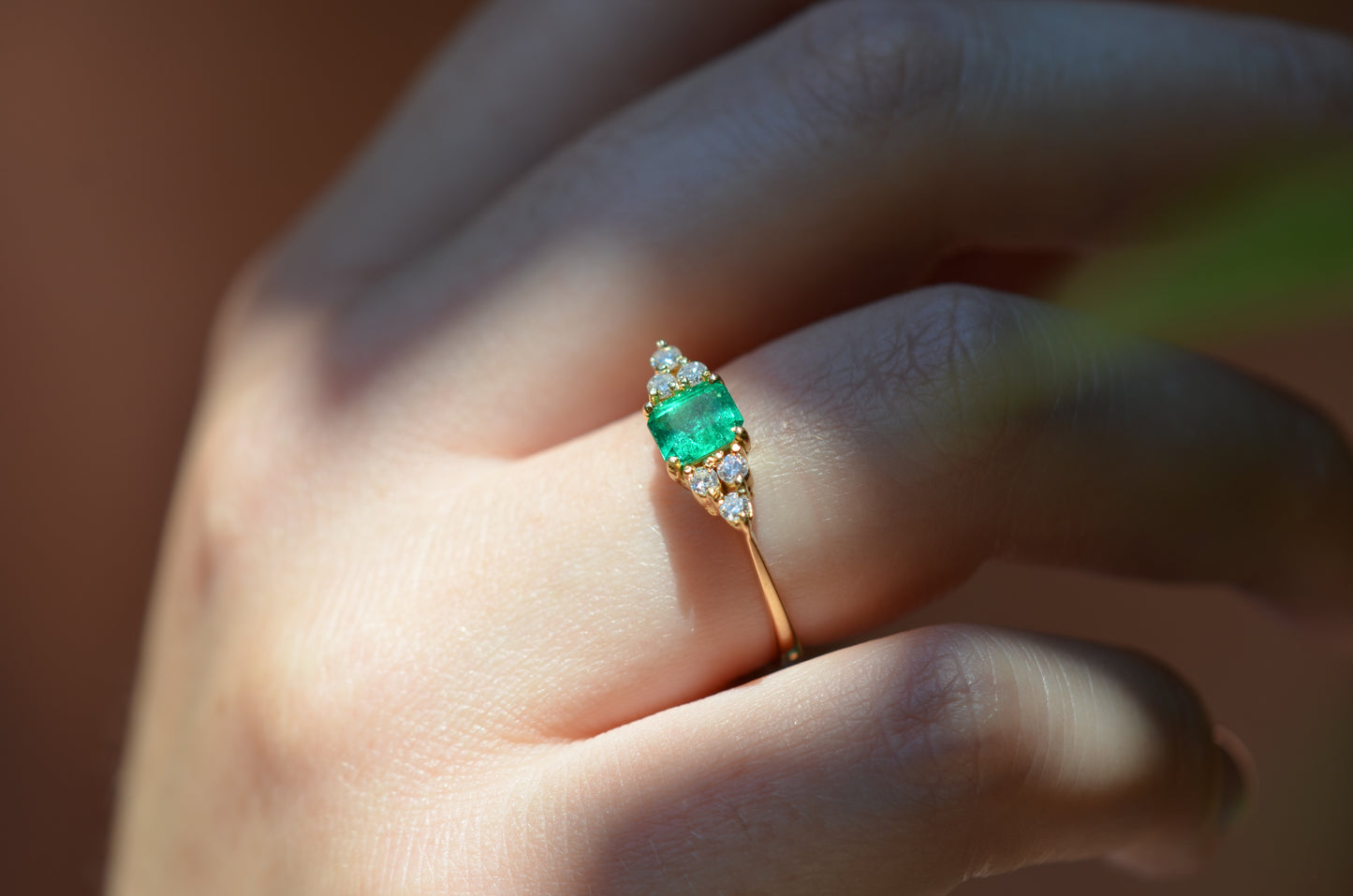 Macro photo of the vintage ring on the hand of a Caucasian model's right ring finger in order to show scale when worn.